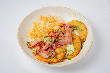 Crispy potato pancakes with sautéed bacon, fresh herbs, and tangy sauerkraut