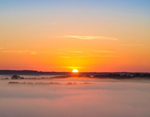 Naklejka premium Sunrise over a sea of mist