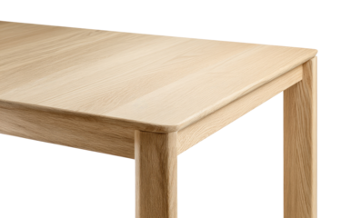 Light-colored wooden table top and leg detail