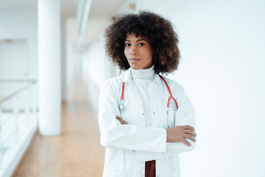 Confident healthcare worker with arms crossed at medical clinic