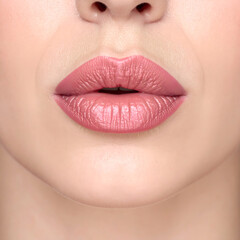Fototapeta premium A sensual close-up of a woman's old rose lips with perfect makeup, highlighting her beauty and glamour