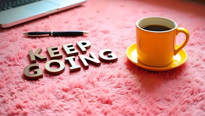Coffee and Laptop on Pink Rug with Keep Going Motivation Quote