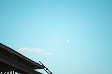 Bright daytime sky with sun and building structure. Perfect for backgrounds, construction, or...