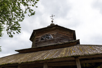 Rustic Wooden Church with Cross Under an Overcast Sky