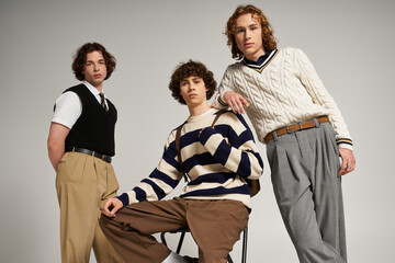 Stylish young friends showcase their fashion choices in a studio setting with creative vibes
