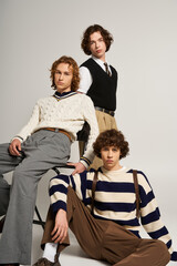Obraz premium Young stylish friends showcase contemporary fashion in a modern studio setting