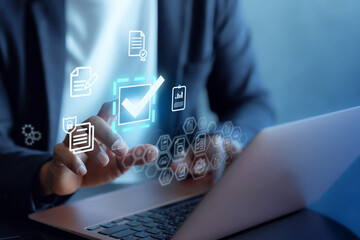 Businessman happy touching approved document icon on digital documents Quality assurance and online evaluation of business concept.