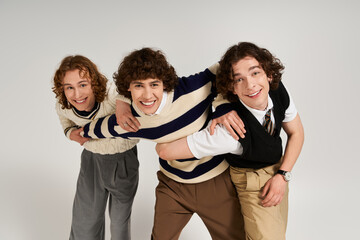 Young stylish friends embracing creativity and friendship in a playful pose together