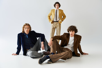 Young stylish friends expressing fashion flair during a vibrant group pose in a studio setting
