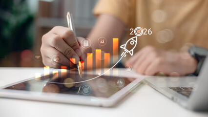 Businessman analyzing data on tablet with 2026 growth strategy, financial chart, and rising bar graph. Future business planning, digital transformation, and success goal concept.