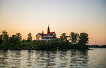 Obraz premium view of historic Villa on island in Helsinki archipelago at sunset