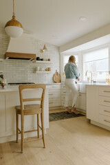 Interior designer working in light and airy kitchen