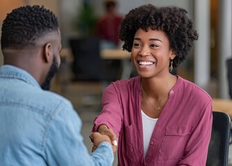 Fototapeta premium Happy businesswoman shaking hands with male boss in modern office environment