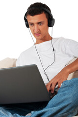 young man with laptop and headphones sitting on sofa at home