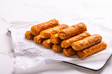 Raw south european skinless sausages cevapcici made of ground meat and spices, ready for a grill
