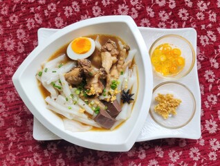 Authentic Thai Kuay Jab with Chicken Feet and Egg on Red Fabric