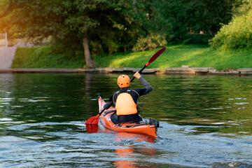 Kayaking enthusiast skillfully maneuvers through calm lake waters, practicing paddling techniques...