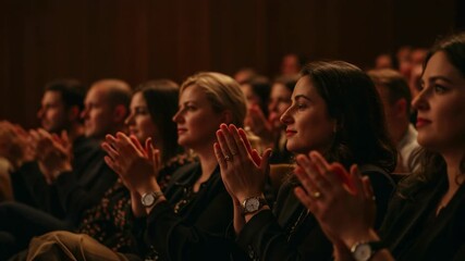 A diverse audience enthusiastically applauds during a captivating performance or event