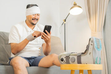 Injured mature man after accident with smart phone sitting on sofa at home