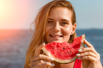 Watermelon Woman Summer Beach: Happy woman enjoys refreshing watermelon slice by seaside on sunny...