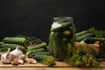 Making pickles. Fresh cucumbers and other ingredients on wooden table