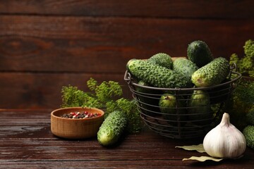Making pickles. Fresh cucumbers and other ingredients on wooden table
