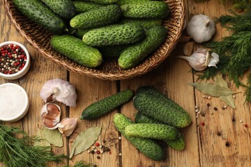 Making pickles. Fresh cucumbers and other ingredients on wooden table, flat lay