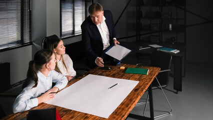 Group brainstorming session in a modern office with a facilitator presenting ideas