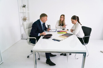 Business meeting in a modern office with team discussing project designs