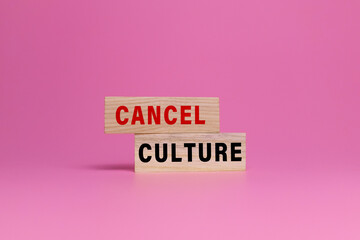cancel culture words on wooden blocks isolated on pink background