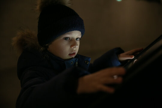 Little boy studying information board