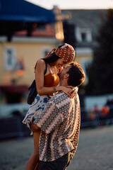 Happy couple of festival goers in love at summer sunset.
