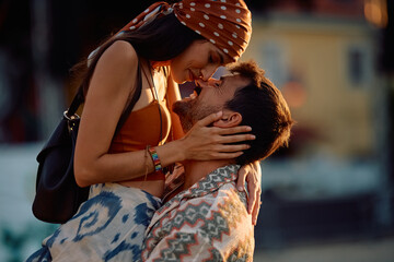 Affectionate couple enjoying in their love while attending summer music festival.