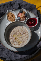Reserved breakfast at a cafe. A plate of porridge on a table in a street cafe. 