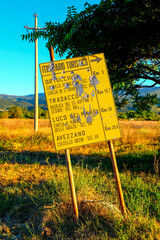 A old, yellow tourist sign for 