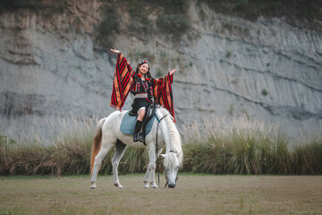 Woman in Traditional Attire Riding Horse with Open Arms Outdoor Scene