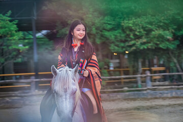Young Girl Riding White Horse in Outdoor Equestrian Setting