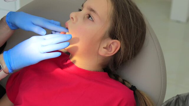 Girl getting dental impression taken during orthodontic consultation