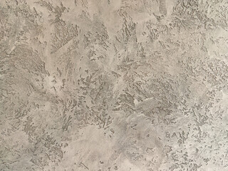 Decorative warm gray venetian plaster wall background, smooth, seamless luxury stucco surface for architecture, art and highend interior design.
