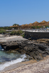 Beautiful beach with umbrellas and sunbeds on the island of Sardinia Italy