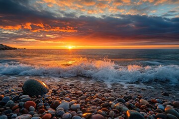 Dramatic sunset over colorful pebble beach