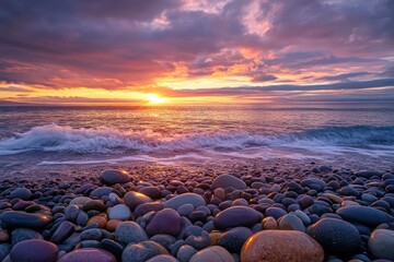 Dramatic sunset over colorful pebble beach