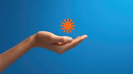 A woman's hand holding an orange sun icon against a blue background. Positive energy and warmth. Good vibes only