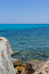 Rocky beach and turquoise water of the Mediterranean Sea in Italy 