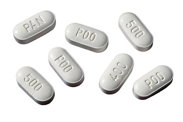 White oval pills arranged randomly on black background showcasing embossed lettering and numbers