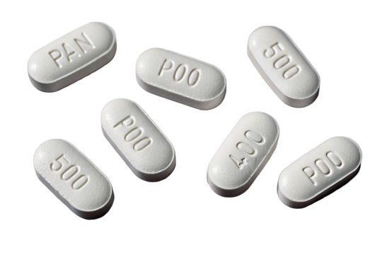 White oval pills arranged randomly on black background showcasing embossed lettering and numbers