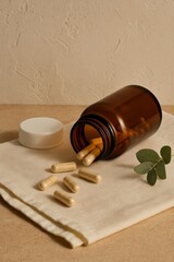 A bottle of pills spilling onto a neutral surface. A close-up captures the scene, emphasizing health and well-being.