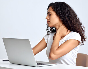 Young woman in plain clothes massaging her stiff neck while working at a computer, professional composition, clean white background, studio lighting