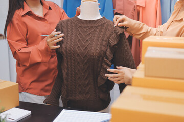Portrait of Starting small businesses SME owners, two Asian woman check online orders Selling...