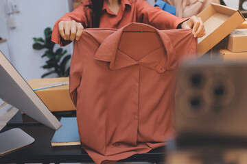 Portrait of Starting small businesses SME owners, two Asian woman check online orders Selling...